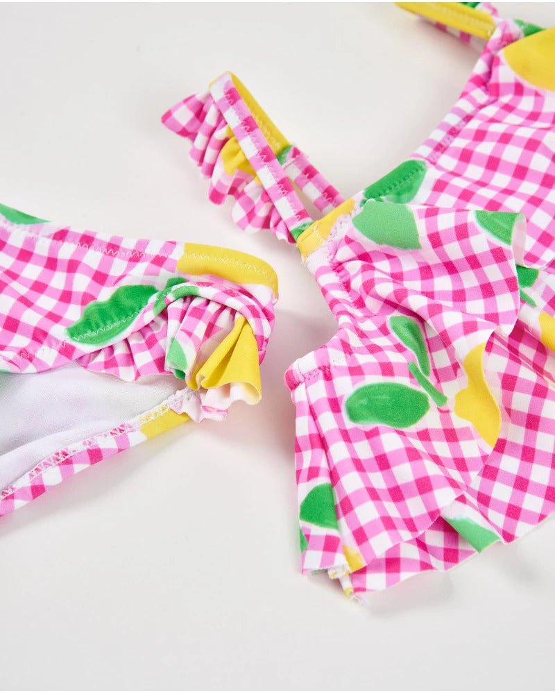 Girl's knitted bikini on a gingham background