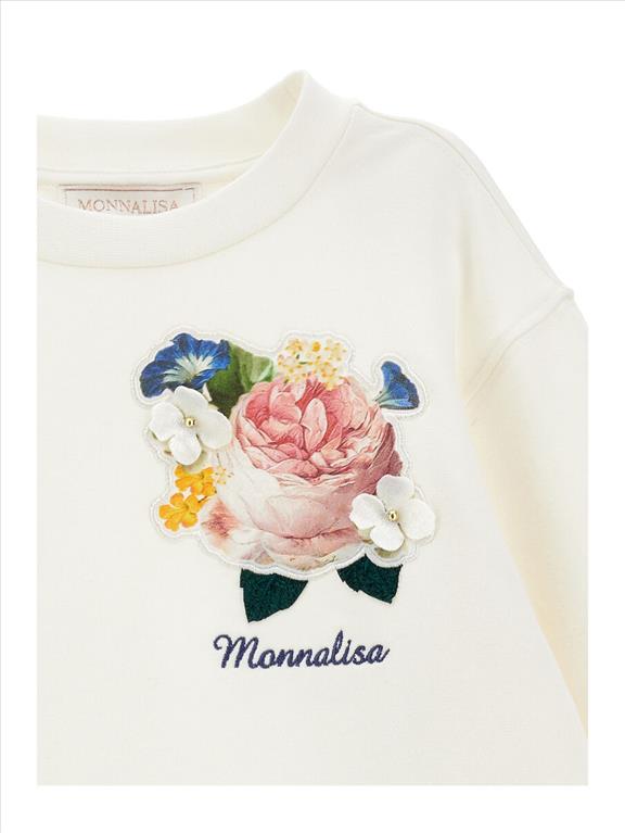Vestito in felpa da bambina decorato con toppe a fiori.