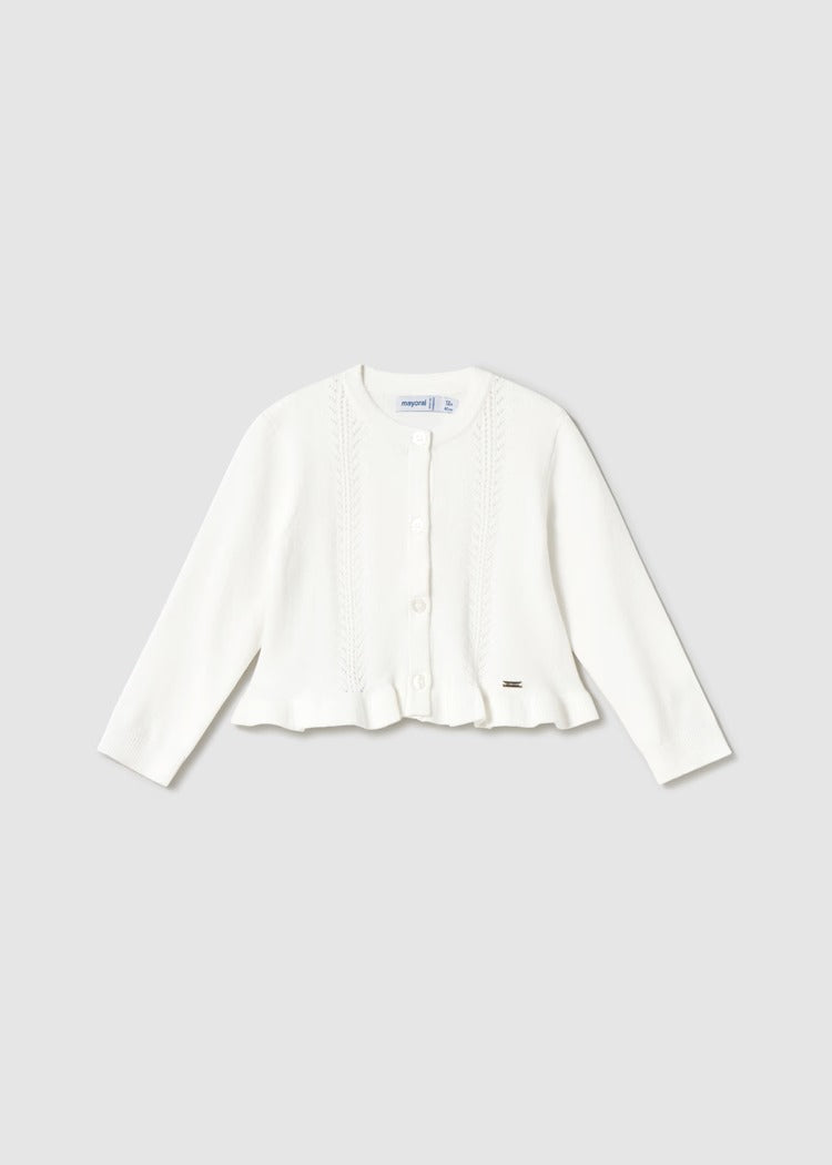 Cardigan in maglia con volant in vita. Chiusura con bottoncini.